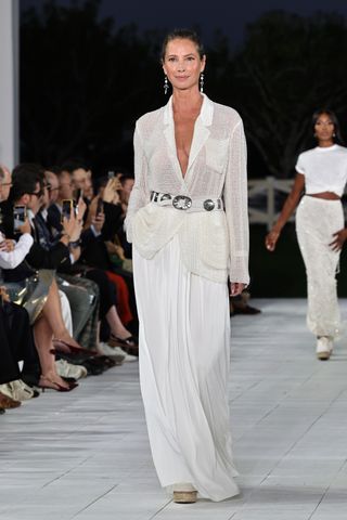 Christy Turlington walks the runway at Ralph Lauren's spring/summer 2025 runway show at new york fashion week wearing a white outfit