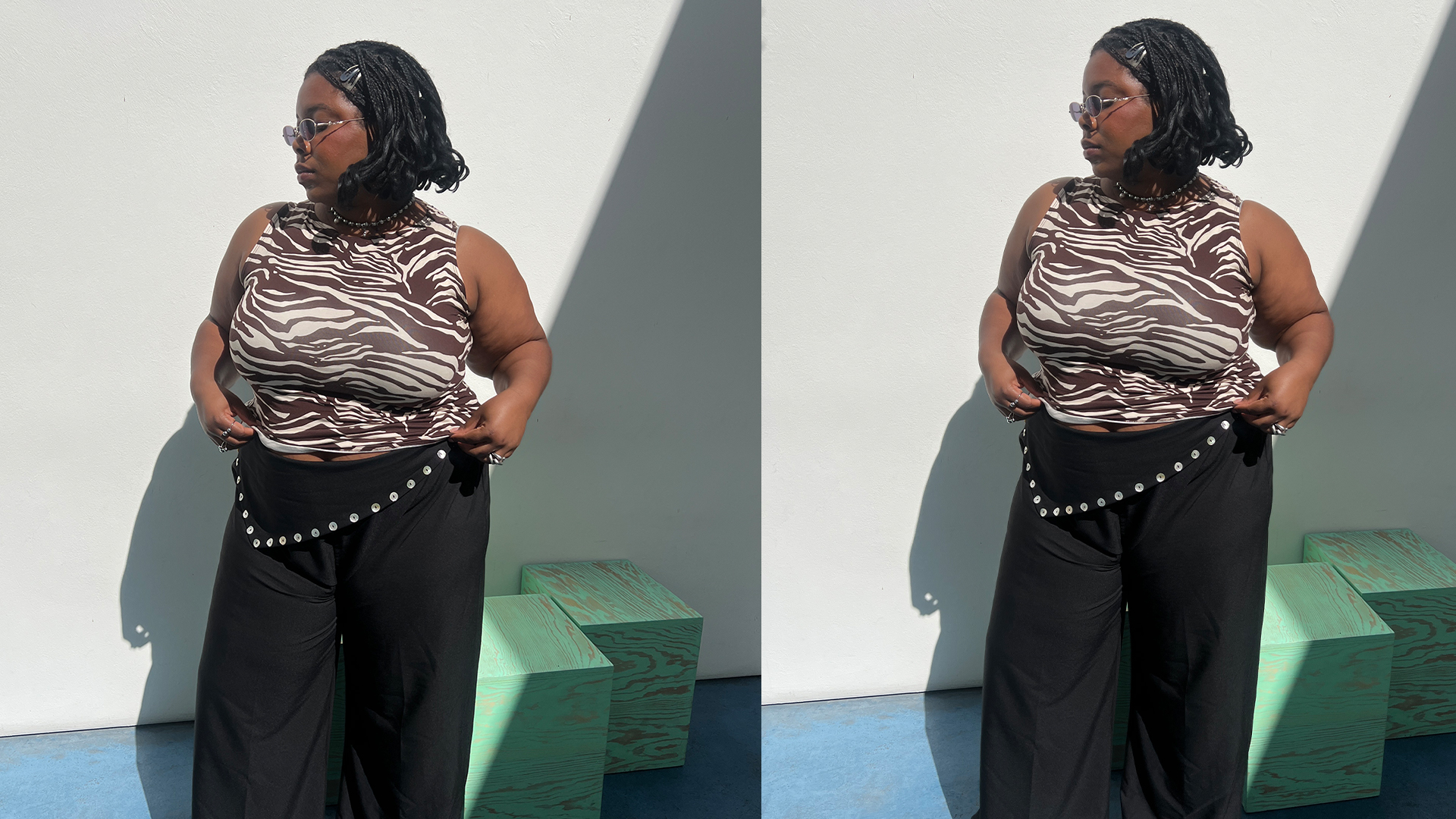 Chichi wears zebra print ref tank and black pants while posing. 