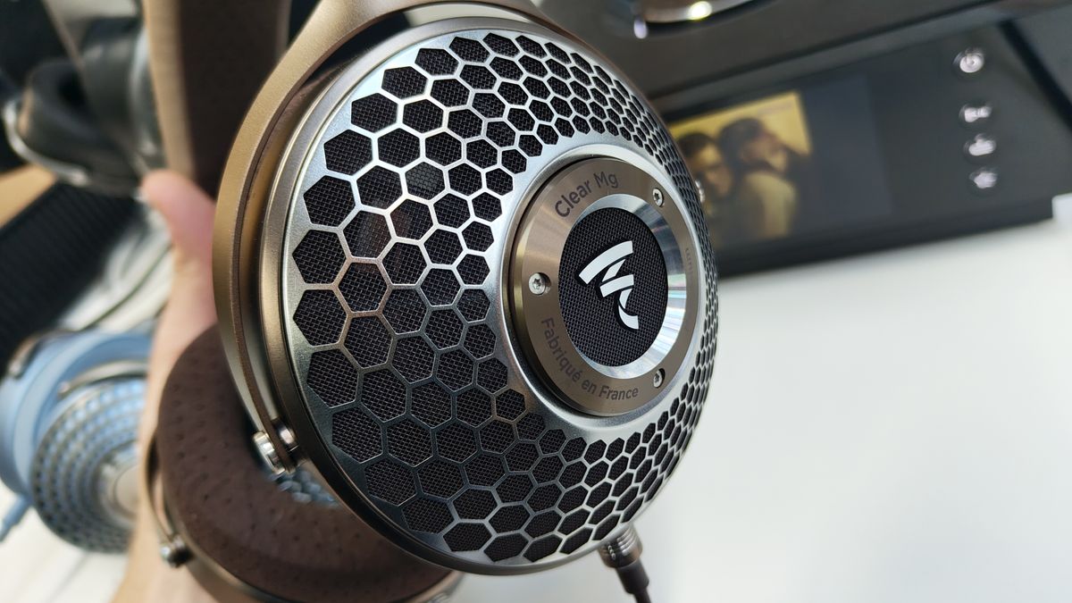 A close-up of the textured earcup of the Focal Clear Mg headphones, which are positioned on a headphone stand. These are our pick for best luxury audiophile headphones.