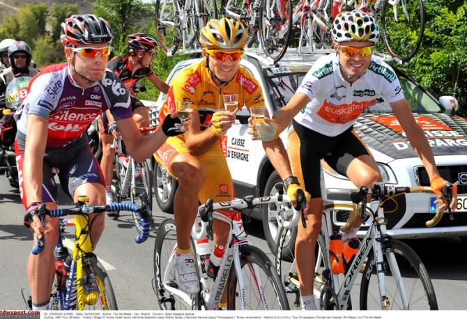 The top three riders toast each at the 2009 podium. Evans was third overall
