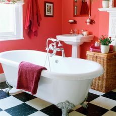 bathroom with bathtub and red wall