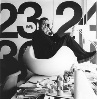 Eero Aarnio with his ’Pastille’ chair, in his studio