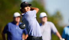 Charlie Woods hits a tee shot with a driver