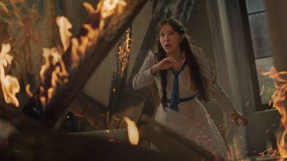 Millie Bobby Brown as Enola Holmes in Enola Holmes 3, stuck in a burning building