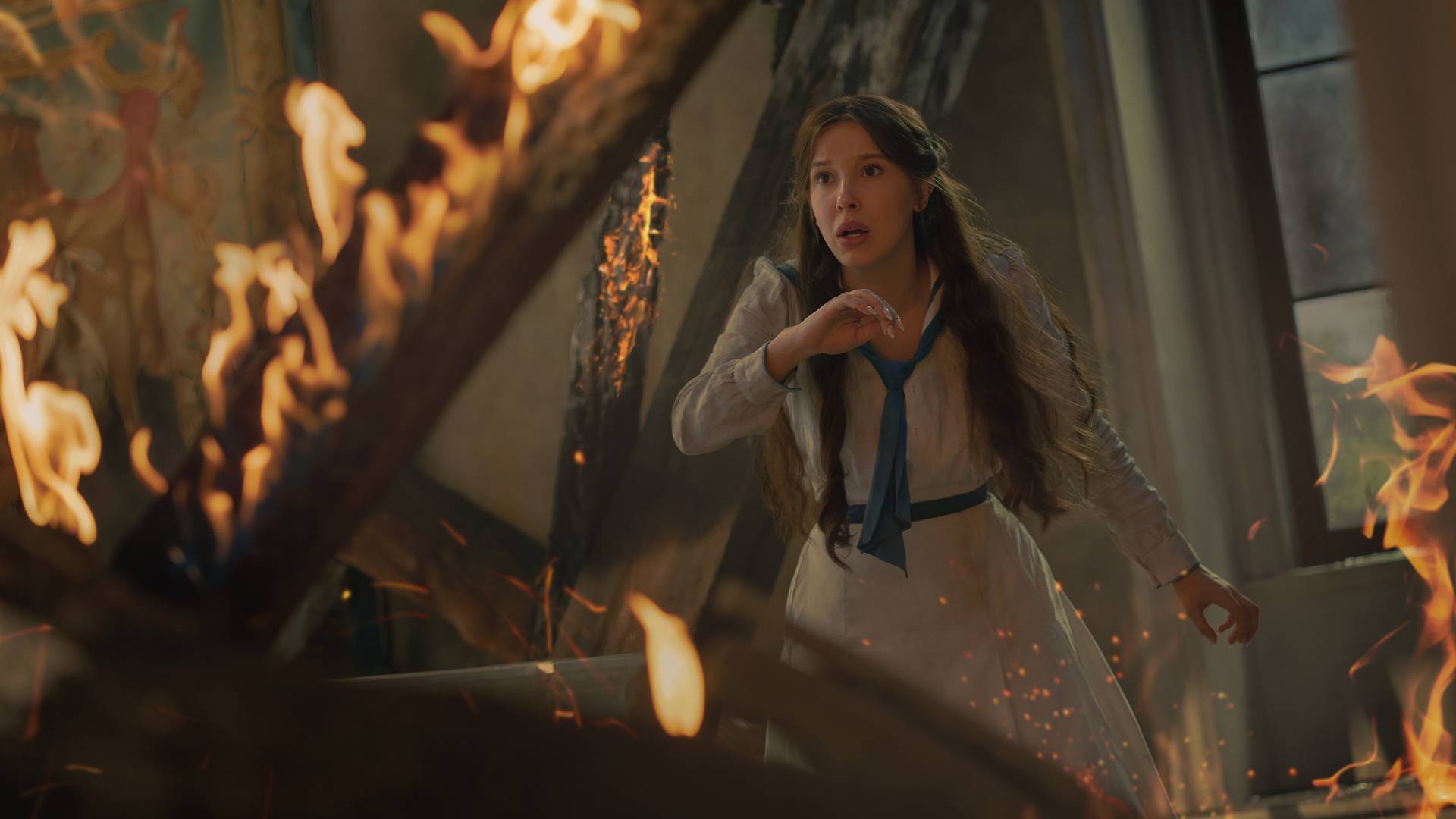 Millie Bobby Brown as Enola Holmes in Enola Holmes 3, stuck in a burning building