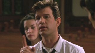 Chris Isaak gestures with his finger as he quotes scripture in a church in That Thing You Do!