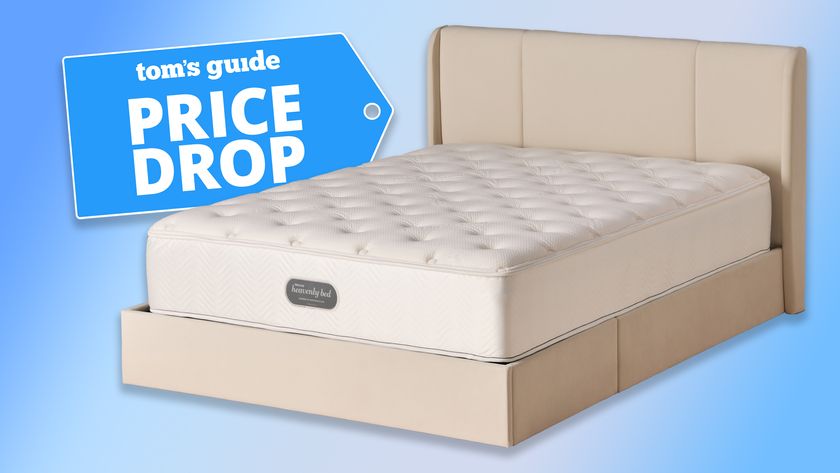 The Westin Heavenly Bed luxury hotel mattress on an upholstered bed frame against a blue background, a Tom&#039;s Guide Price Drop deals graphic in the top left