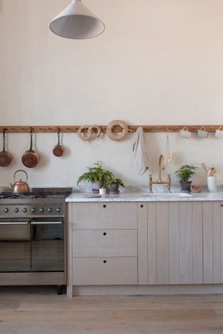 Save space hack in the kitchen with hanging utensils