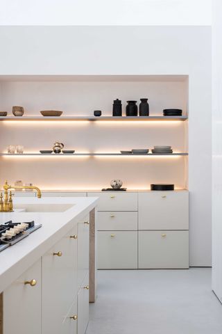 a kitchen with led strip lit shelving