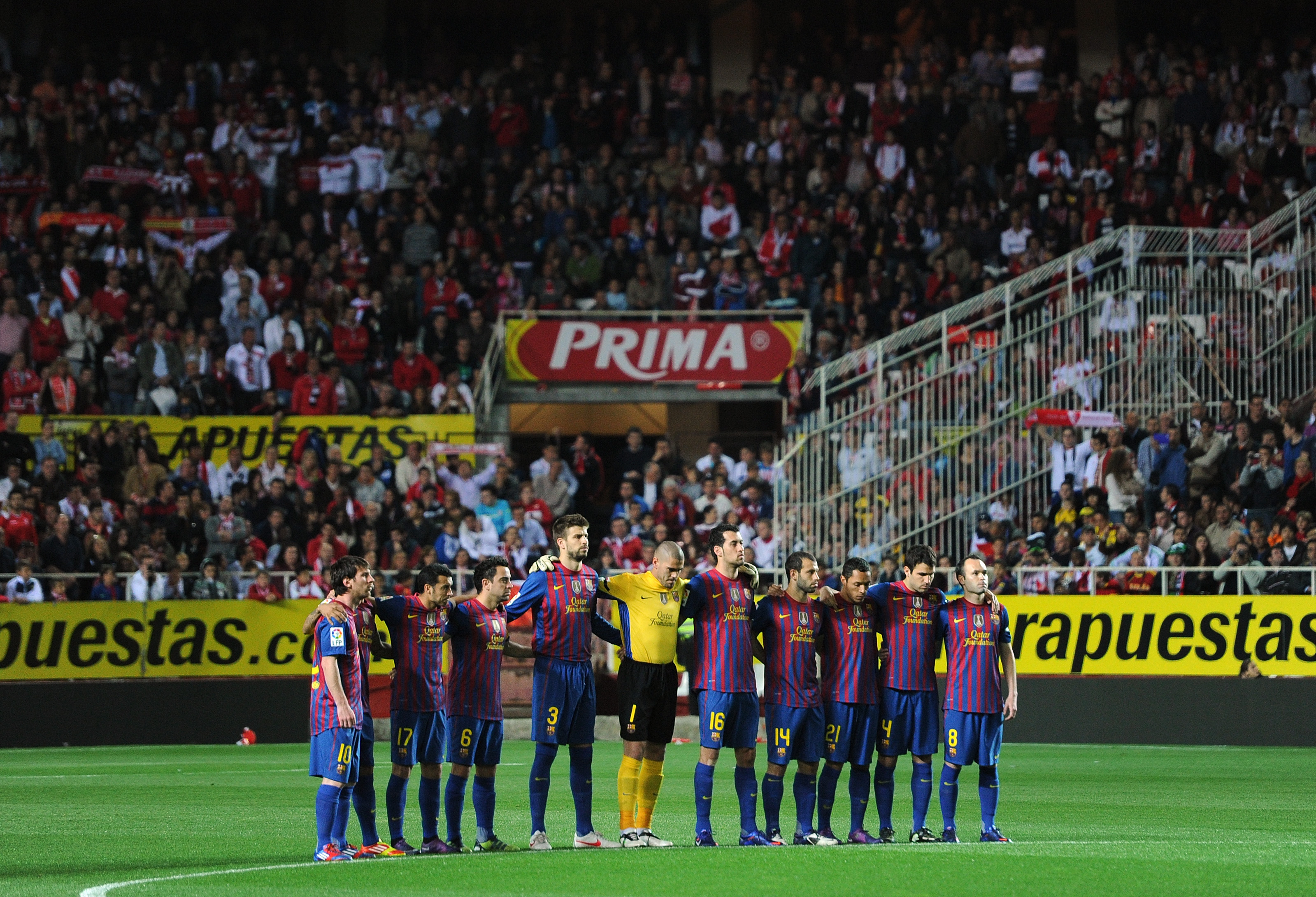 Barcelona players observe a minute's silence following the death of their former winger Estanislau Basora ahead of a La Liga game against Sevilla in March 2012.