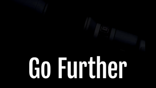 The text &#039;Go Further&#039; overlayed on a very dark picture of a silhouetted camera lens