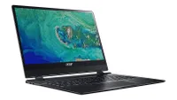 Acer Swift 7 ultrabook shown in gunmetal colourway on white background with screen open and showing a screensaver of the Earth shown from satellite image, location unknown