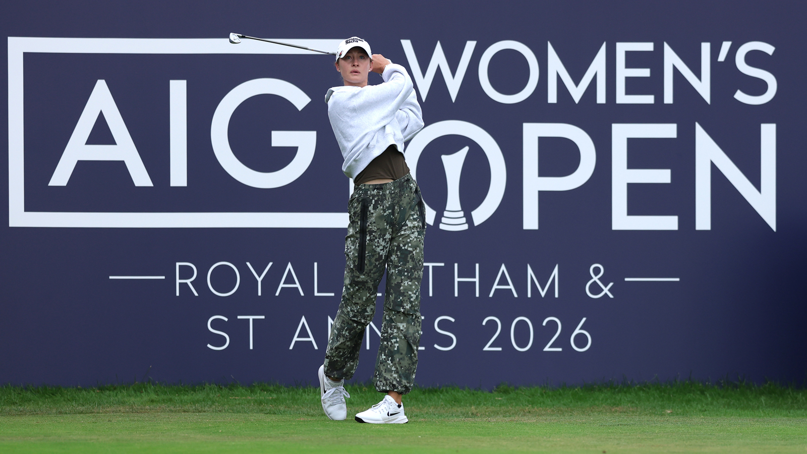 Nelly Korda hits a tee shot in front of an AIG Women's Open board