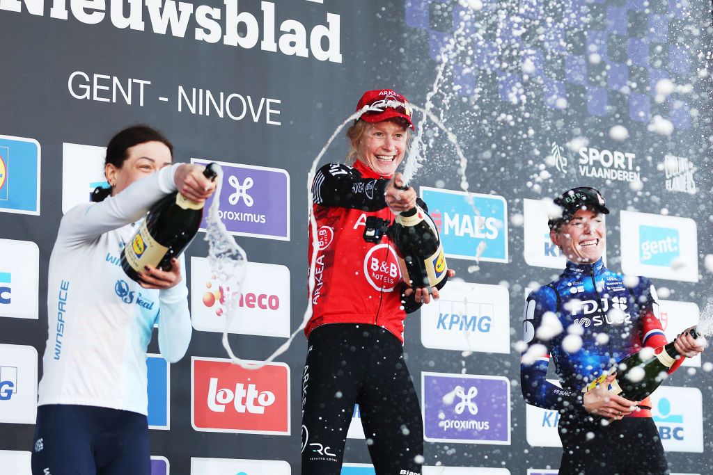 NINOVE BELGIUM MARCH 01 LR Aurela Nelos of Poland and Team Winspace Orange Seal on second place race winner Lotte Claes of Belgium and Team Arkea BB Hotels Women and Demi Vollering of Netherlands and Team FDJ Suez on third place pose on the podium ceremony after the 17th Omloop Het Nieuwsblad 2025 Womens Elite a 1379km one day race from Ghent to Ninove UCIWWT on March 01 2025 in Ninove Belgium Photo by Rhode Van ElsenGetty Images