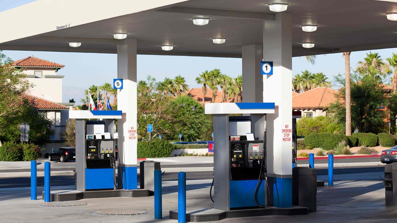 picture of gas station with palm trees in the background