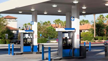 picture of gas station with palm trees in the background