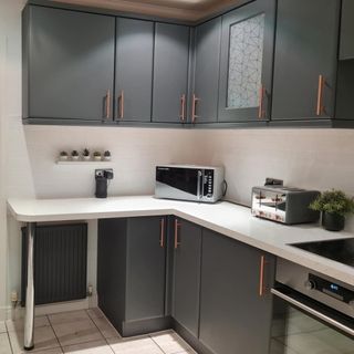grey kitchen units and microwave