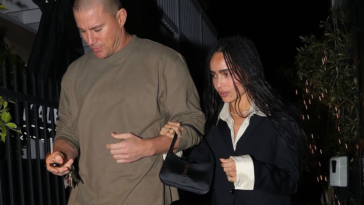 Zoe Kravitz with Channing Tatum in a white button down, black coat, and purple shoes