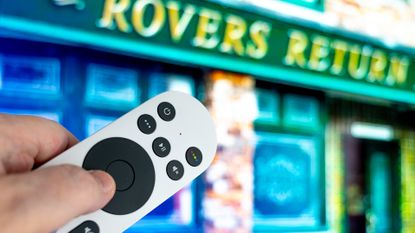 Sky Glass remote control pointing at TV with Coronation Street background