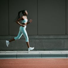How to run for longer: A woman on a jog in blue gym kit