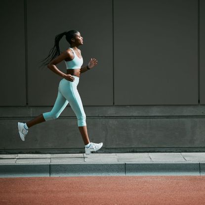 How to run for longer: A woman on a jog in blue gym kit