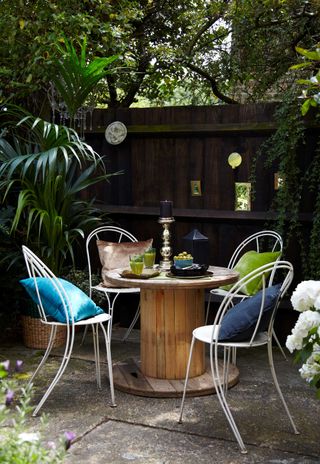 urban garden seating with black fence and mirrors