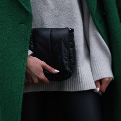 Sarah Posch seen wearing Mango light grey wool knit high neck jumper / sweater, Gant green wool long coat, Mango black leather skinny pants, Weekday black leather bag, December 13, 2023 in Berlin, Germany