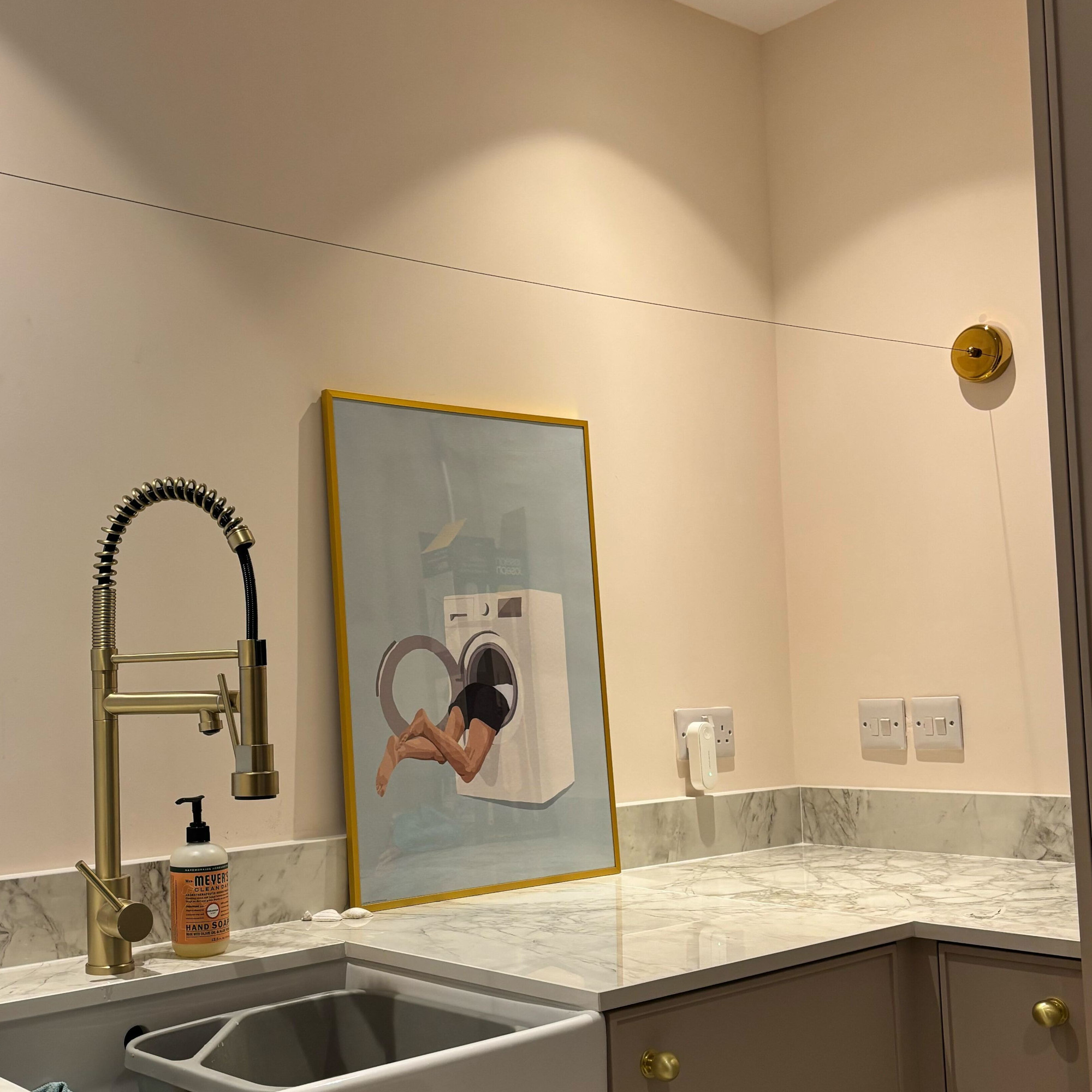 brass retractable clothes line in a laundry room