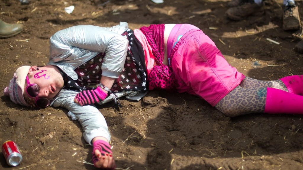 A festival goer asleep or passed out on the floor