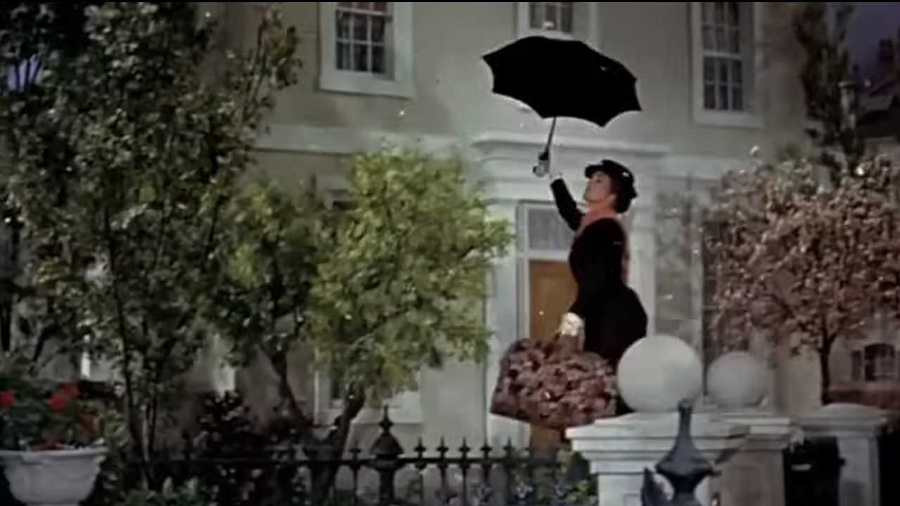 Julie Andrews as Mary Poppins flying in with her umbrella