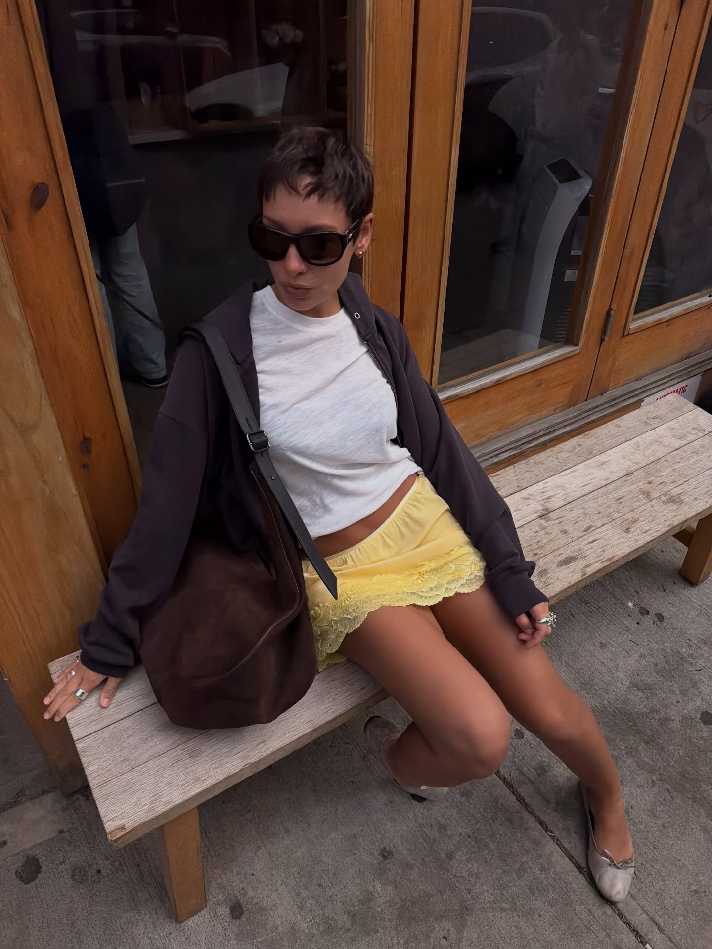 Woman in a lace-trim skirt, t-shirt, and ballet flats.