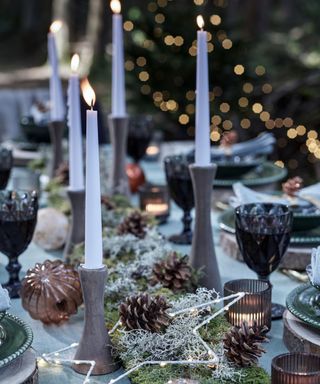 Candle holders, moss, pinecones, starlight