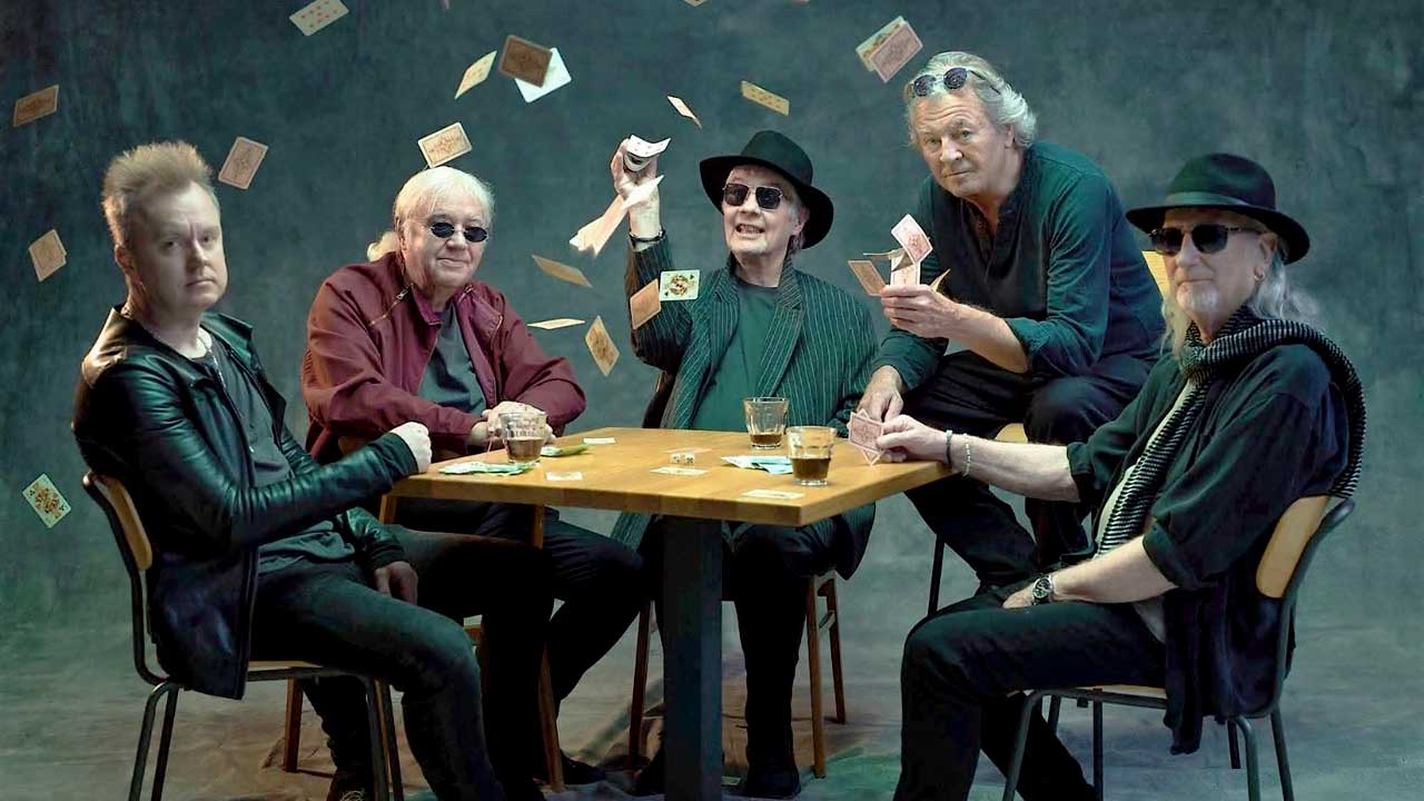 Deep Purple seated at a cards table