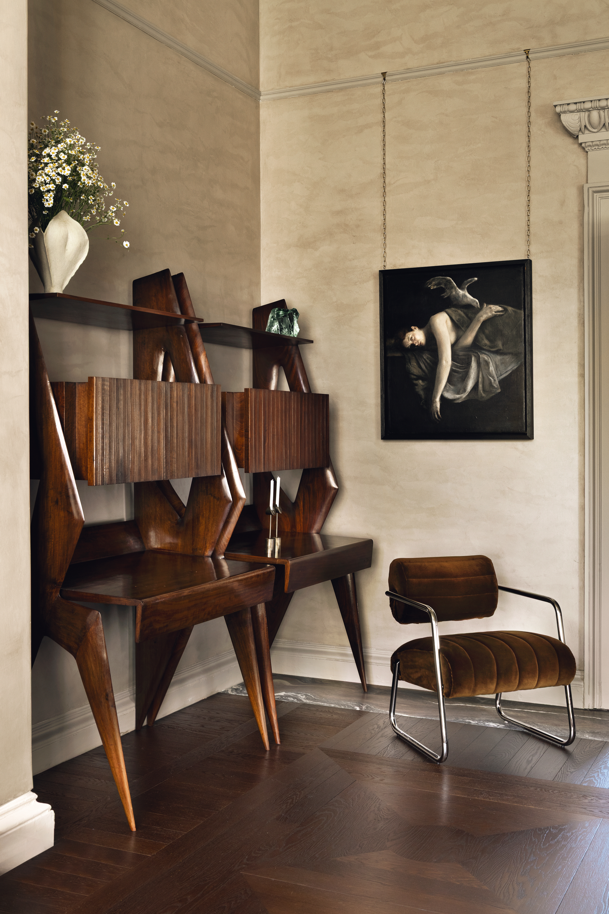 Roisin Lafferty's new gallery - a corner with dark wood desks and a mid-century-style chrome-framed chair in dark brown velvet