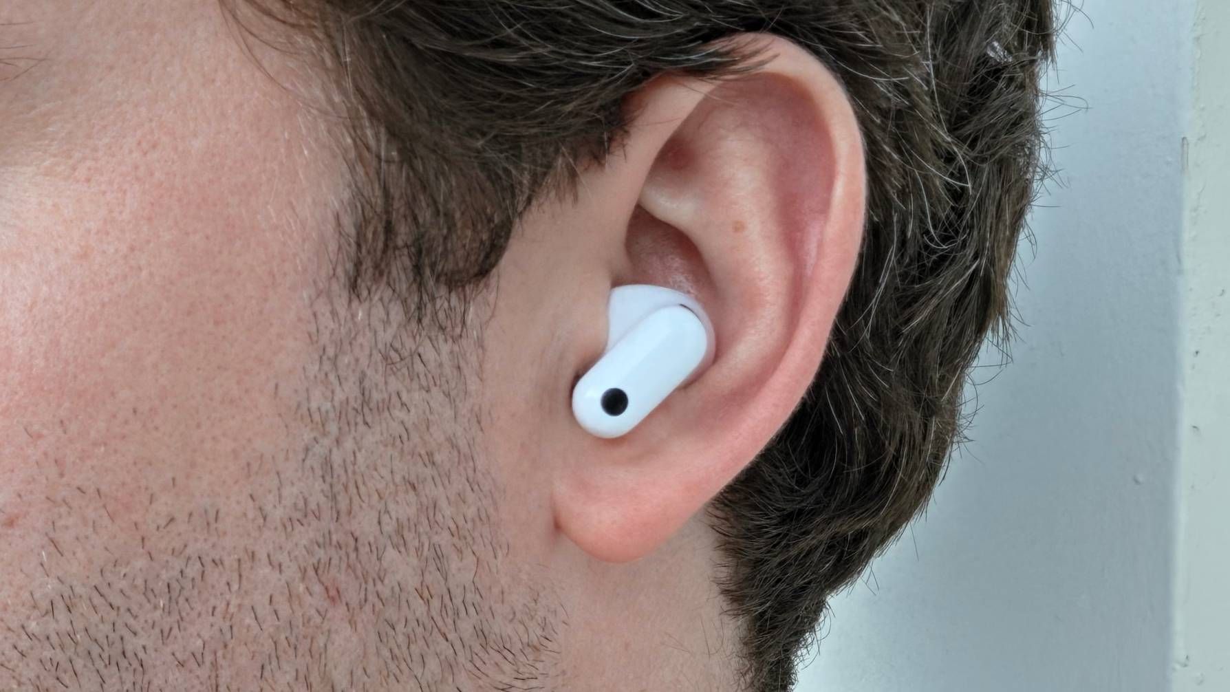 The Huawei FreeBuds Neo bud in a man's ear.