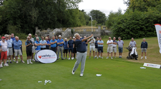 Colin Montgomerie hitting an iron at a clinic