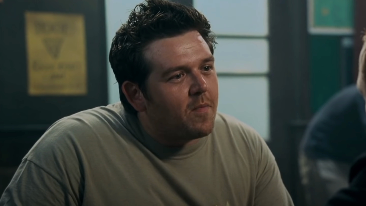 Nick Frost sits smiling in The Winchester in Shaun of the Dead.