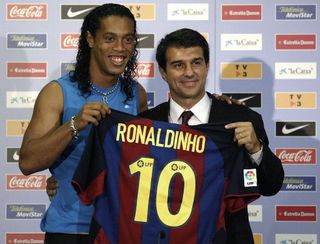 Ronaldinho poses with Barcelona president Joan Laporta after signing for the Catalan club in July 2003.