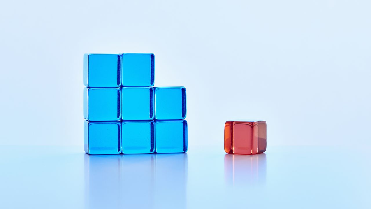 Six stacked blue blocks to the left and one red black to the right.