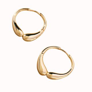 Flat lay image of gold hoop earrings