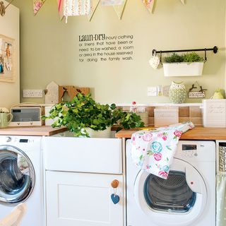clean laundry area with white washing machine