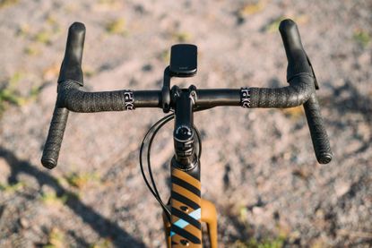 A set of the best handlebars for off-road riding set up on a gravel bike that's pictured on a trail