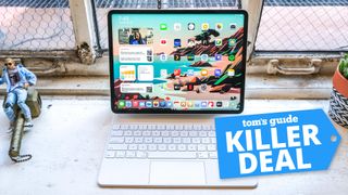 iPad Pro 2021 with Magic Keyboard on a desk with a Tom's Guide deal tag