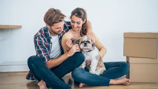 Man and woman cuddle a dog together