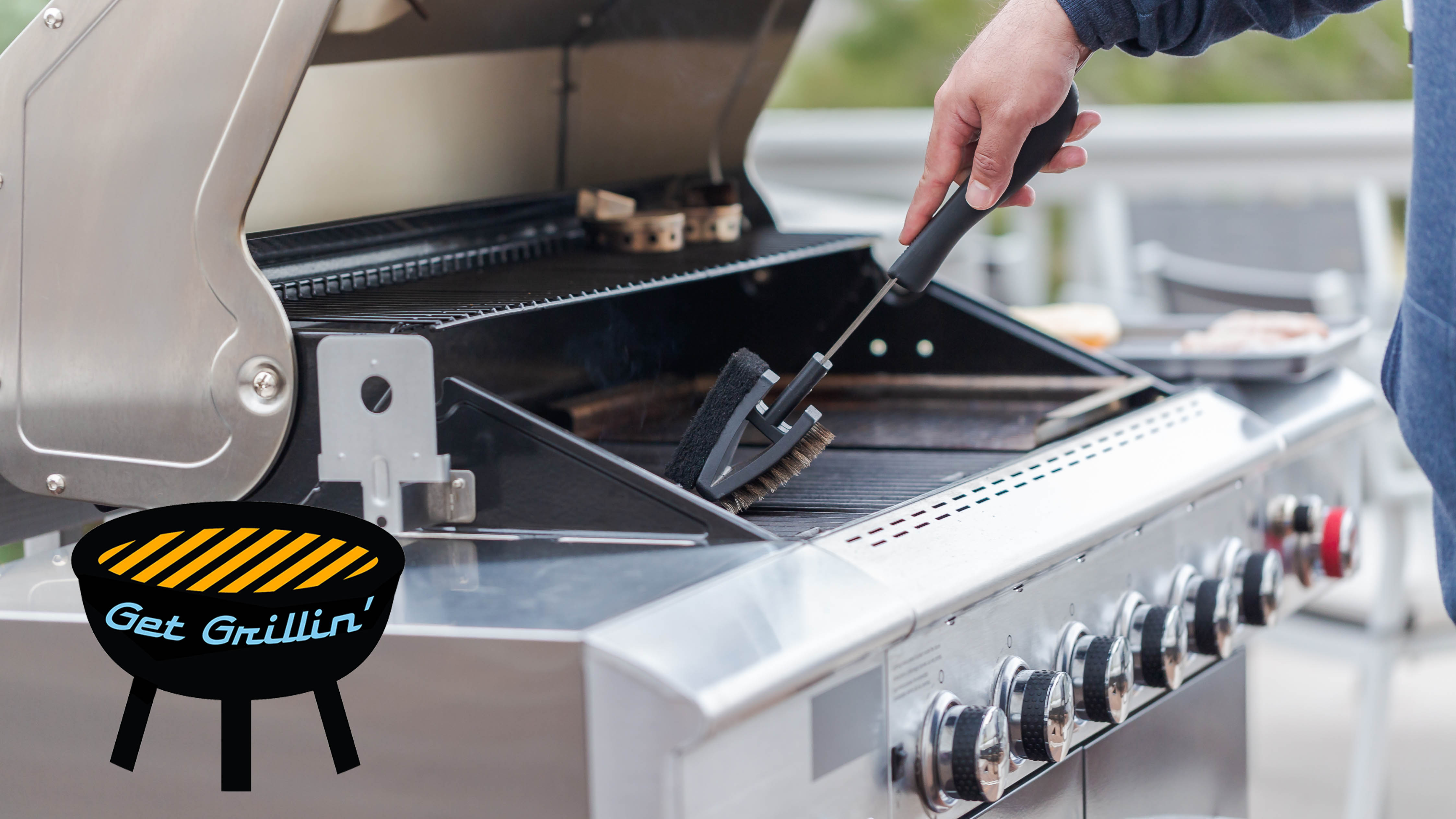 Man cleaning a grill with a brush