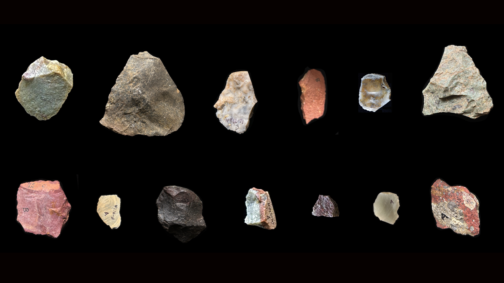 a series of different colored stone tools against a black background