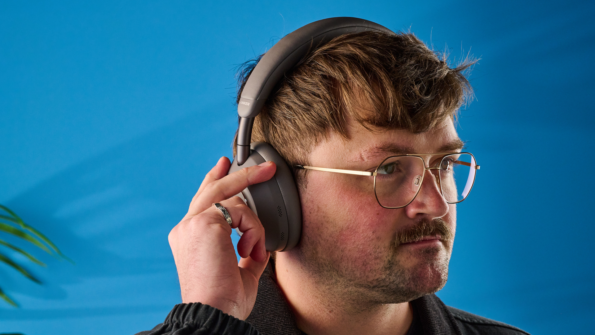 the anker soundcore space 2 pro headphones in mauve gray photographed against a blue tom's guide background