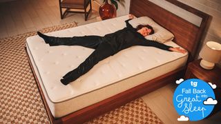 The Tom's Guide Sleep Features Editor, Lauren Jeffries, lying on her back on a mattress in a starfish position, smiling happily