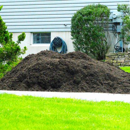 huge pile of mulch on driveway
