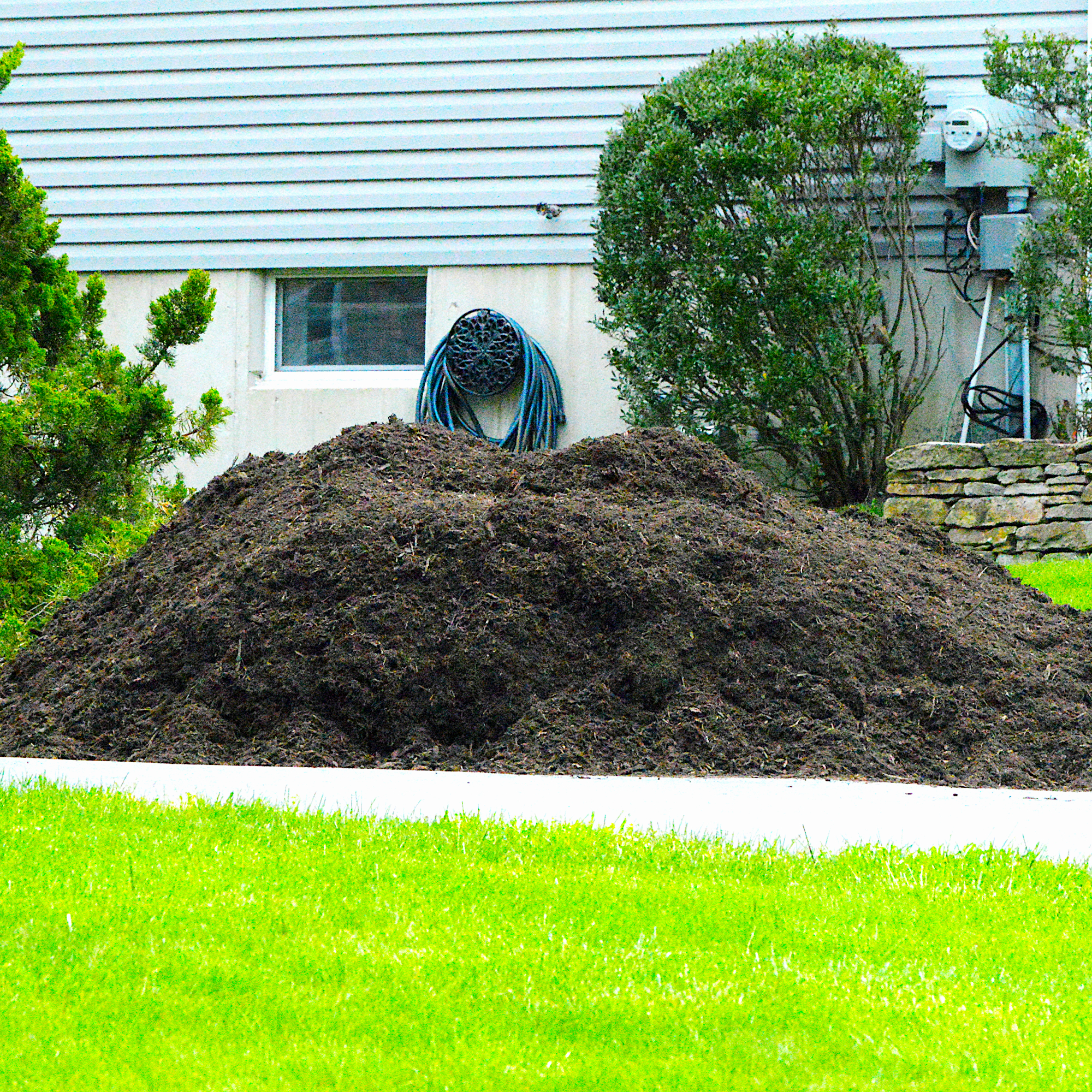 huge pile of mulch on driveway